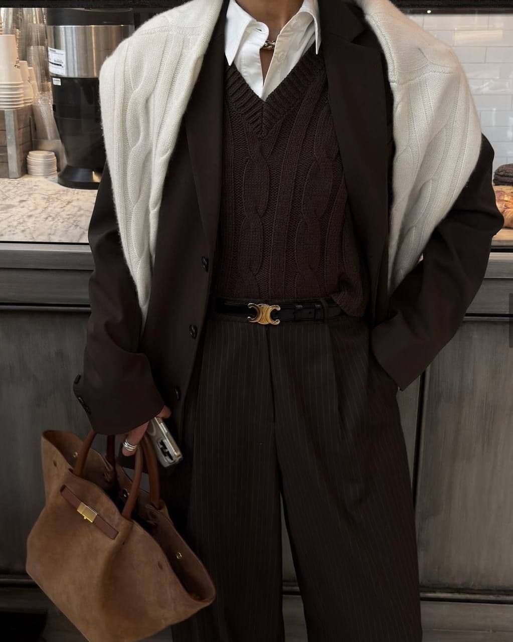 A sharply dressed consultant holding a bag.